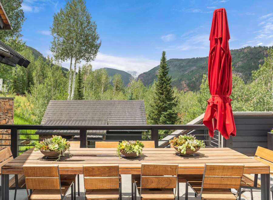 Enjoy breathtaking mountain views from this stunning outdoor dining area, perfect for al fresco meals.