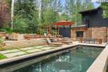 Experience luxury outdoor living with this stunning backyard oasis, featuring a sparkling swimming pool and a modern fire pit area perfect for evening gatherings.