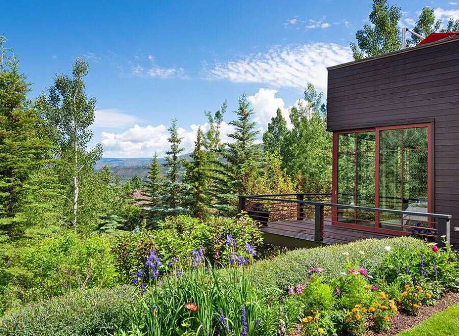 Experience breathtaking mountain views from this stunning modern home, featuring a spacious deck perfect for outdoor entertaining.