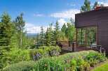 Experience breathtaking mountain views from this stunning modern home, featuring a spacious deck perfect for outdoor entertaining.