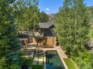 Experience luxury outdoor living with this stunning property featuring a pristine swimming pool and a relaxing hot tub, perfect for unwinding.