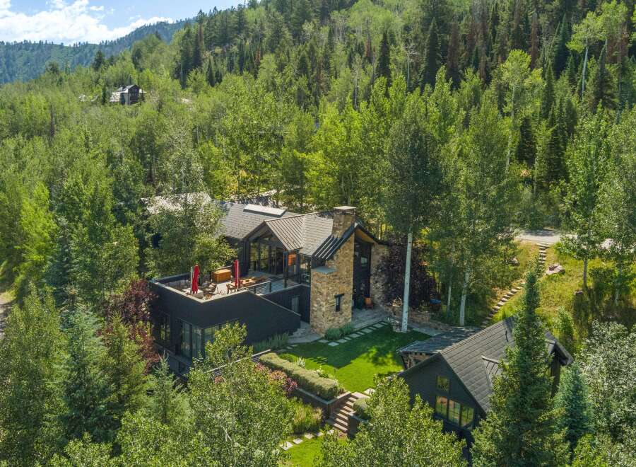 Experience luxury mountain living in this stunning contemporary home nestled amidst lush greenery.