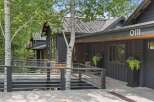 Experience modern mountain living in this stunning dark-clad home, featuring a sleek metal roof and a welcoming ramp leading to the entrance.