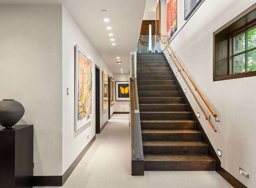 Experience luxury living in this stunning home featuring a grand staircase and a beautifully appointed hallway.