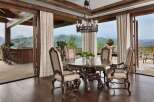 Experience luxurious mountain living in this exquisite dining room, featuring a grand wooden table and chairs perfect for intimate gatherings.