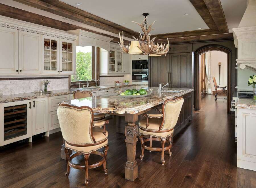 Experience luxury in this stunning kitchen featuring a grand island with a granite countertop, perfect for entertaining.