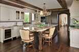 Experience luxury in this stunning kitchen featuring a grand island with a granite countertop, perfect for entertaining.