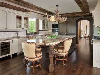 Experience luxury in this stunning kitchen featuring a grand island with a granite countertop, perfect for entertaining.