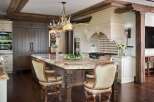 Experience luxury in this stunning kitchen featuring a grand marble island with comfortable bar stools, perfect for entertaining.