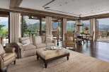 Experience luxurious mountain living in this stunning great room, featuring expansive windows that frame breathtaking panoramic views of the surrounding peaks.