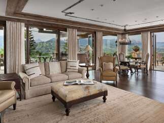 Experience luxurious mountain living in this stunning great room, featuring expansive windows that frame breathtaking panoramic views of the surrounding peaks.