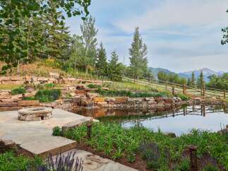 Experience luxury outdoor living with this stunning water feature and fire pit area, perfect for entertaining or quiet relaxation.