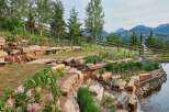 Discover this stunning mountain retreat featuring a beautifully landscaped garden with a cascading water feature and a tranquil pond.