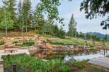Discover this stunning mountain retreat featuring a serene water feature with cascading waterfalls, perfect for relaxation.