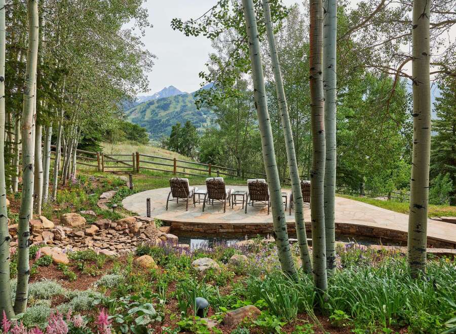 Experience serene mountain living with this stunning outdoor oasis, featuring a multi-level patio perfect for entertaining and relaxation.
