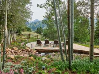 Experience serene mountain living with this stunning outdoor oasis, featuring a multi-level patio perfect for entertaining and relaxation.