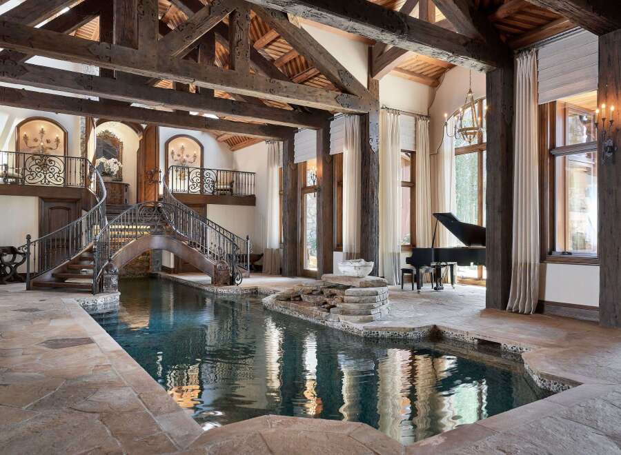 Experience unparalleled luxury in this stunning estate featuring a magnificent indoor pool with a cascading waterfall.
