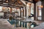 Experience unparalleled luxury in this stunning estate featuring a magnificent indoor pool with a cascading waterfall.