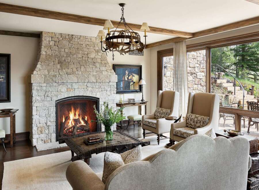 Experience rustic elegance in this inviting living room, featuring a grand stone fireplace as the centerpiece.