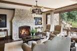 Experience rustic elegance in this inviting living room, featuring a grand stone fireplace as the centerpiece.