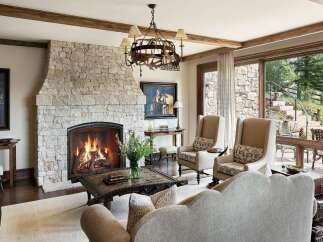 Experience rustic elegance in this inviting living room, featuring a grand stone fireplace as the centerpiece.