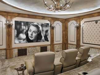 Experience cinematic luxury in this custom home theater, featuring plush reclining seats and a massive screen for an immersive viewing experience.