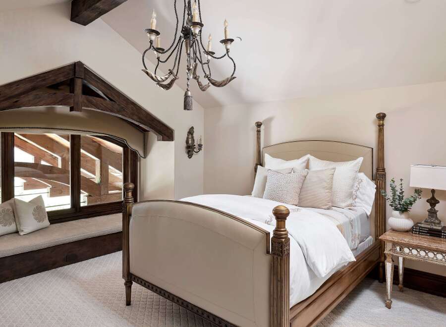 Experience rustic elegance in this charming bedroom, featuring a luxurious four-poster bed adorned with plush pillows and crisp white linens.