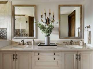 This luxurious bathroom vanity features a dual-sink setup with elegant marble countertops and ornate brass fixtures.