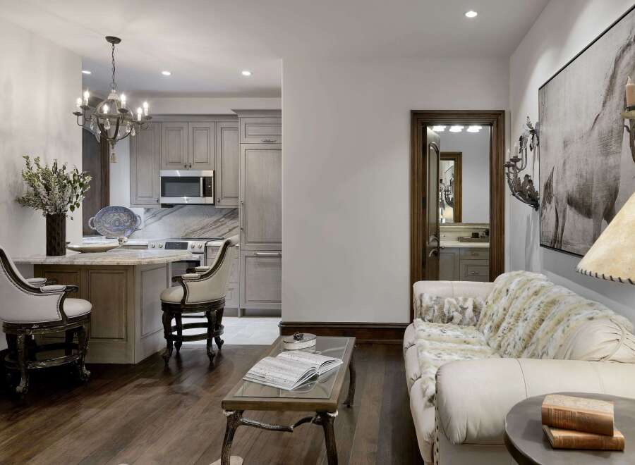 Experience luxury living in this stunning open-concept space, featuring a modern kitchen with sleek cabinetry and a breakfast bar perfect for casual dining.