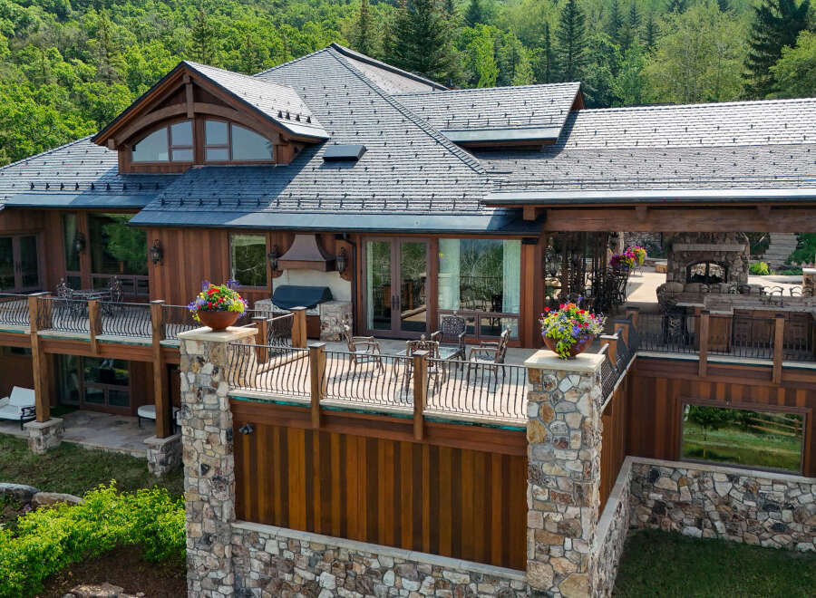 Experience luxury mountain living in this stunning timber-frame home, featuring expansive decks with breathtaking forest views.