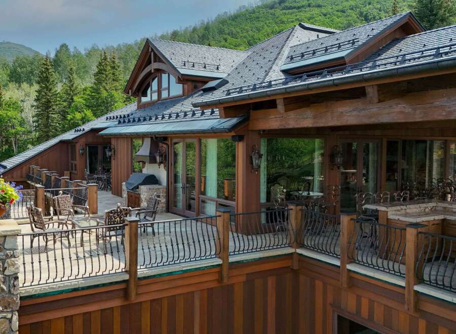 Experience luxury mountain living in this stunning timber-frame home, featuring expansive decks with breathtaking forest views.