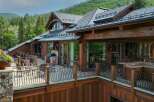 Experience luxury mountain living in this stunning timber-frame home, featuring expansive decks with breathtaking forest views.