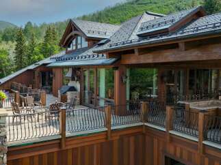 Experience luxury mountain living in this stunning timber-frame home, featuring expansive decks with breathtaking forest views.