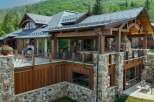 Experience luxury mountain living in this stunning timber-frame home, featuring expansive decks with breathtaking forest views.