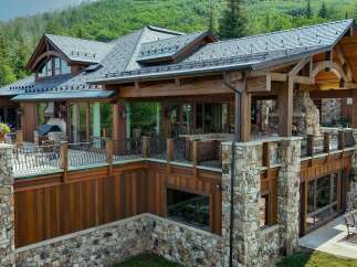 Experience luxury mountain living in this stunning timber-frame home, featuring expansive decks with breathtaking forest views.