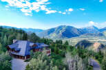 Experience luxury mountain living in this stunning estate, nestled amidst breathtaking panoramic views of the surrounding peaks and valleys.