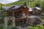 Experience luxury mountain living in this stunning stone and timber home, nestled amidst lush greenery.
