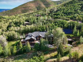 Experience luxury mountain living in this stunning estate nestled amidst lush greenery and rolling hills.