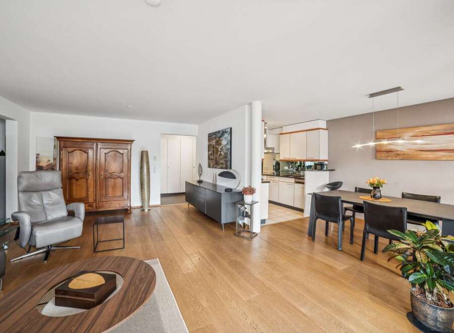 Experience modern living in this spacious open-plan apartment, featuring a sleek kitchen seamlessly integrated with a dining area perfect for entertaining.