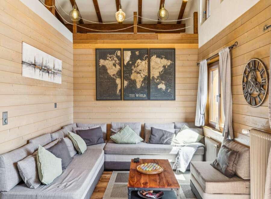 Experience rustic charm in this cozy living room, featuring a sectional sofa perfect for gatherings and a striking world map art piece that sparks wanderlust.