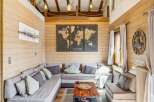 Experience rustic charm in this cozy living room, featuring a sectional sofa perfect for gatherings and a striking world map art piece that sparks wanderlust.