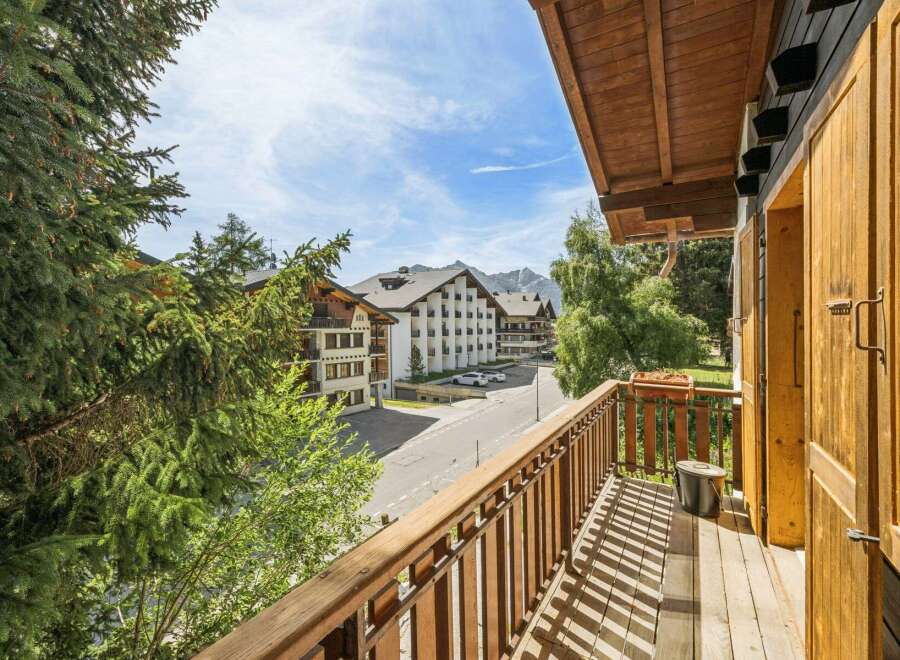 Enjoy stunning mountain views from this charming balcony, perfect for your alpine getaway.