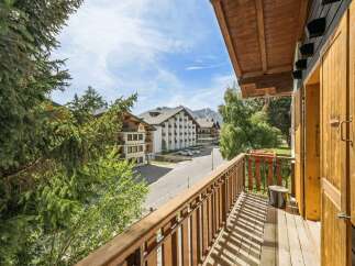 Enjoy stunning mountain views from this charming balcony, perfect for your alpine getaway.