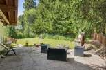 Enjoy outdoor living in this charming backyard featuring a spacious patio perfect for entertaining.