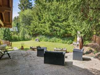 Enjoy outdoor living in this charming backyard featuring a spacious patio perfect for entertaining.