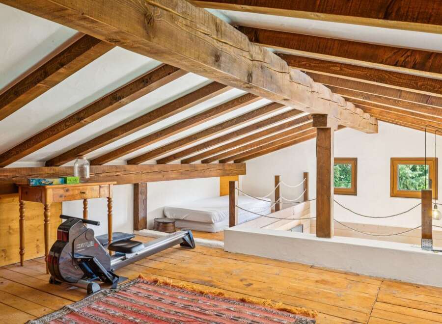Discover this unique loft space featuring exposed wooden beams and a rustic charm.