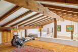 Discover this unique loft space featuring exposed wooden beams and a rustic charm.
