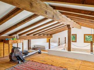 Discover this unique loft space featuring exposed wooden beams and a rustic charm.