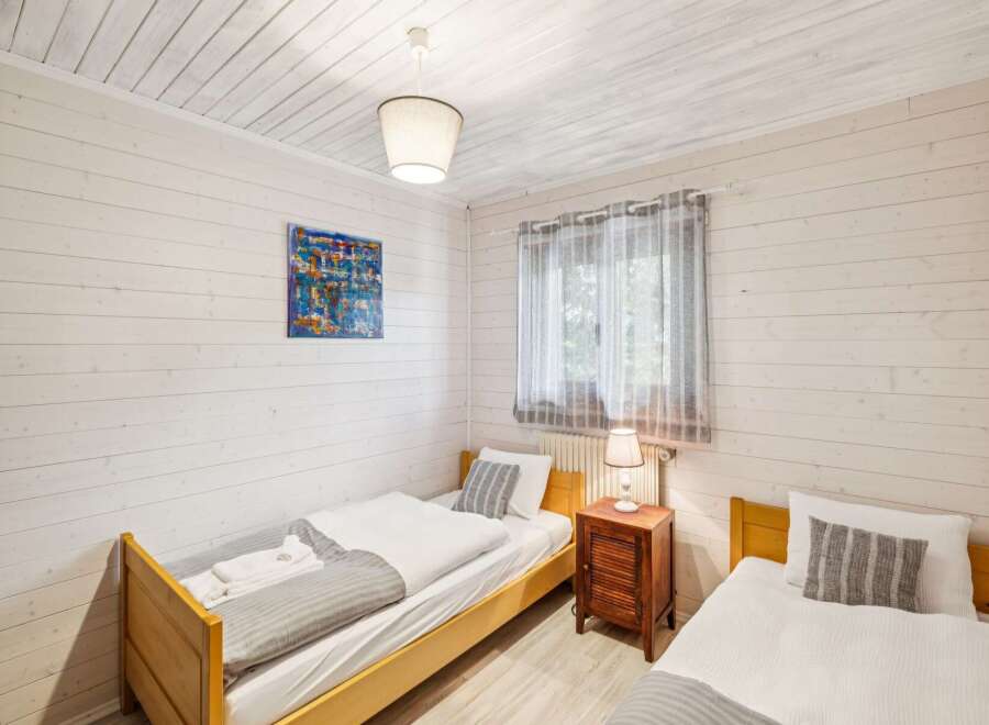 This charming bedroom features two cozy twin beds, perfect for guests or a family.