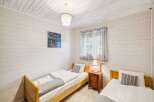 This charming bedroom features two cozy twin beds, perfect for guests or a family.